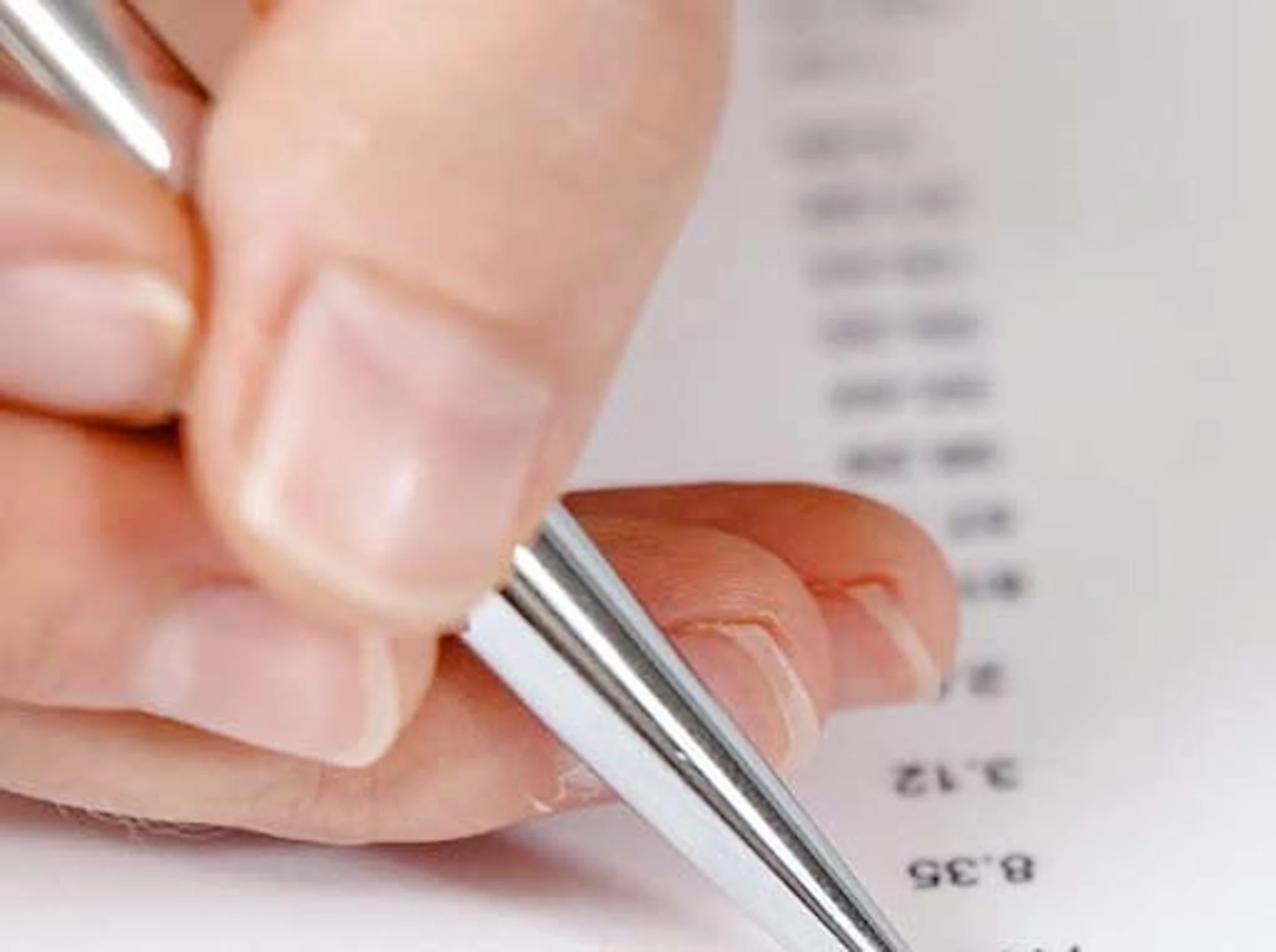 Lady using a pen to mark a financial document
