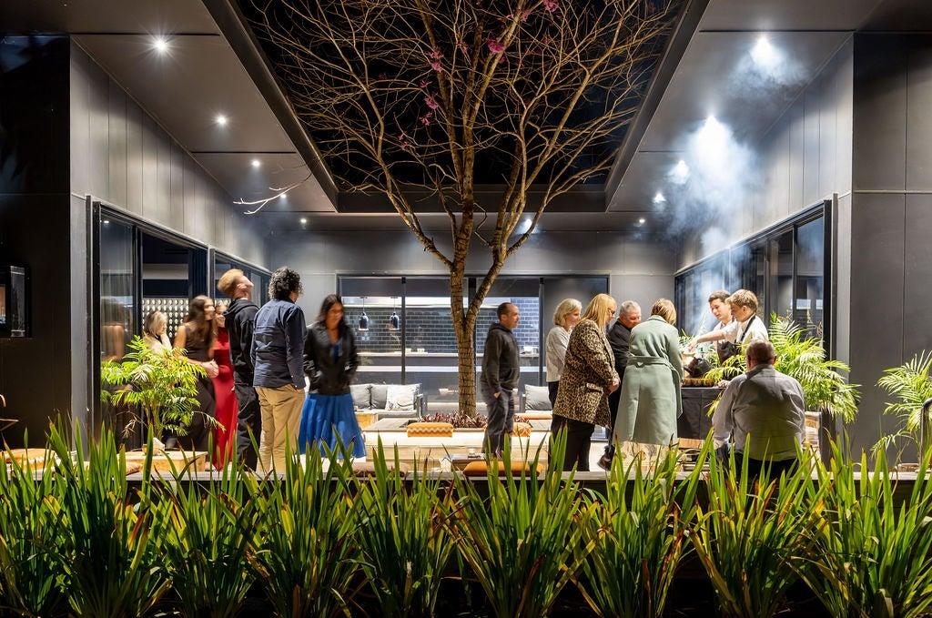 A beautiful tree without it's leaves, people milling around below