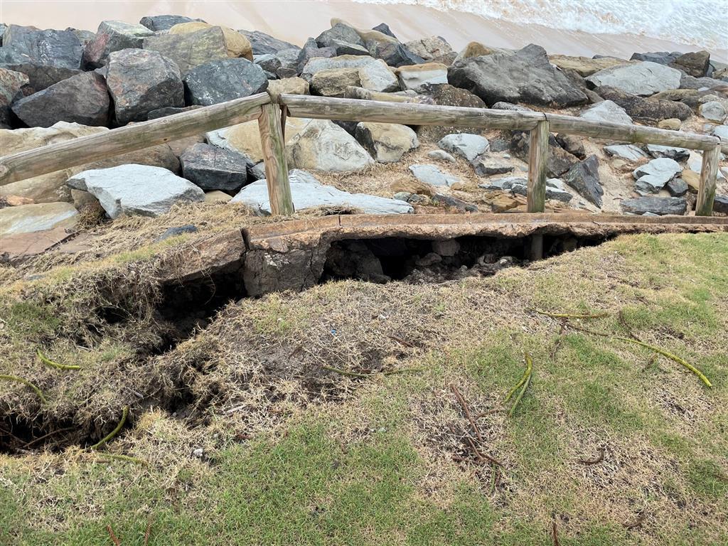 Cracks in the ground indicate damage to the Moffat Beach Seawall - March 2022.