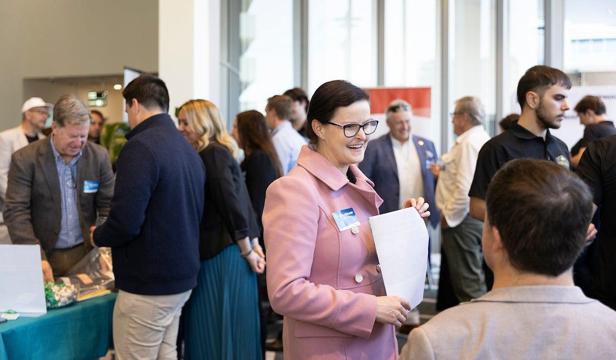 People at the Thriving Through Change event talk to exhibitors.