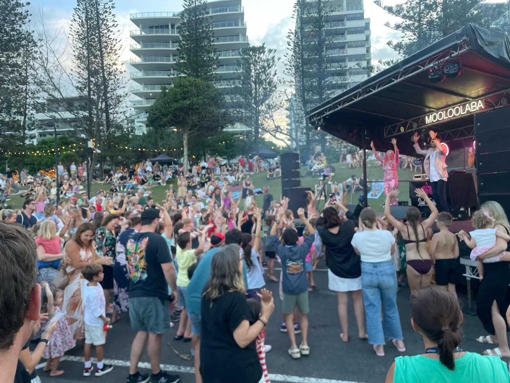 A crowd of people standing in front of a stage at NYE Mooloolaba