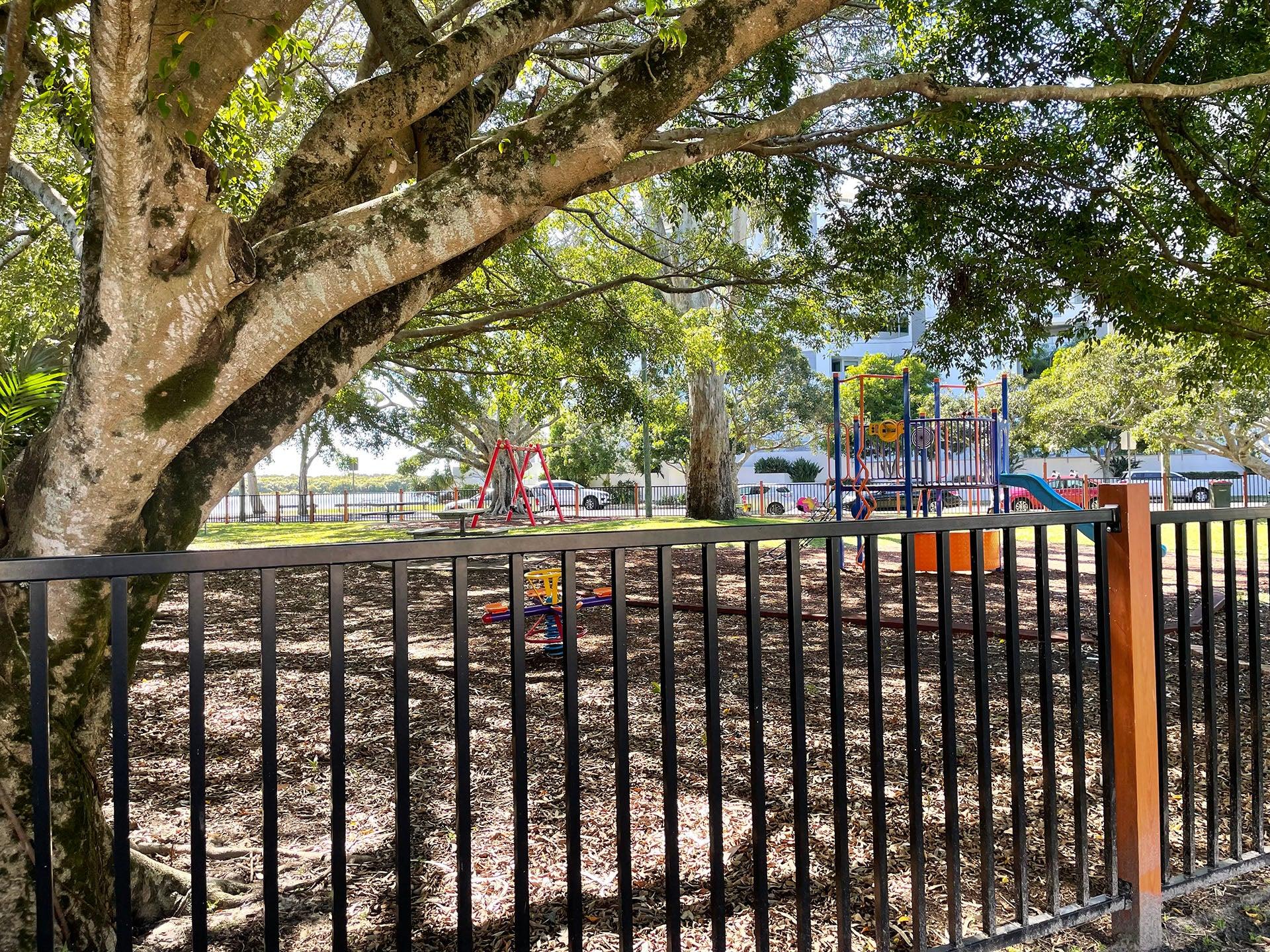 Fenced playground with natural shade