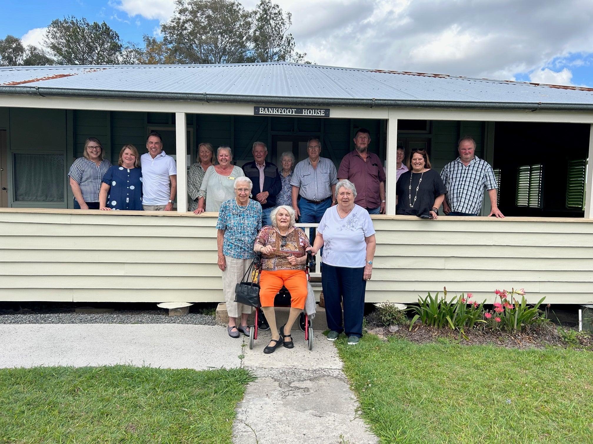 Celebrating 155 years of Bankfoot House. Image shows the front of Bankfoot House with attendees on the verandah