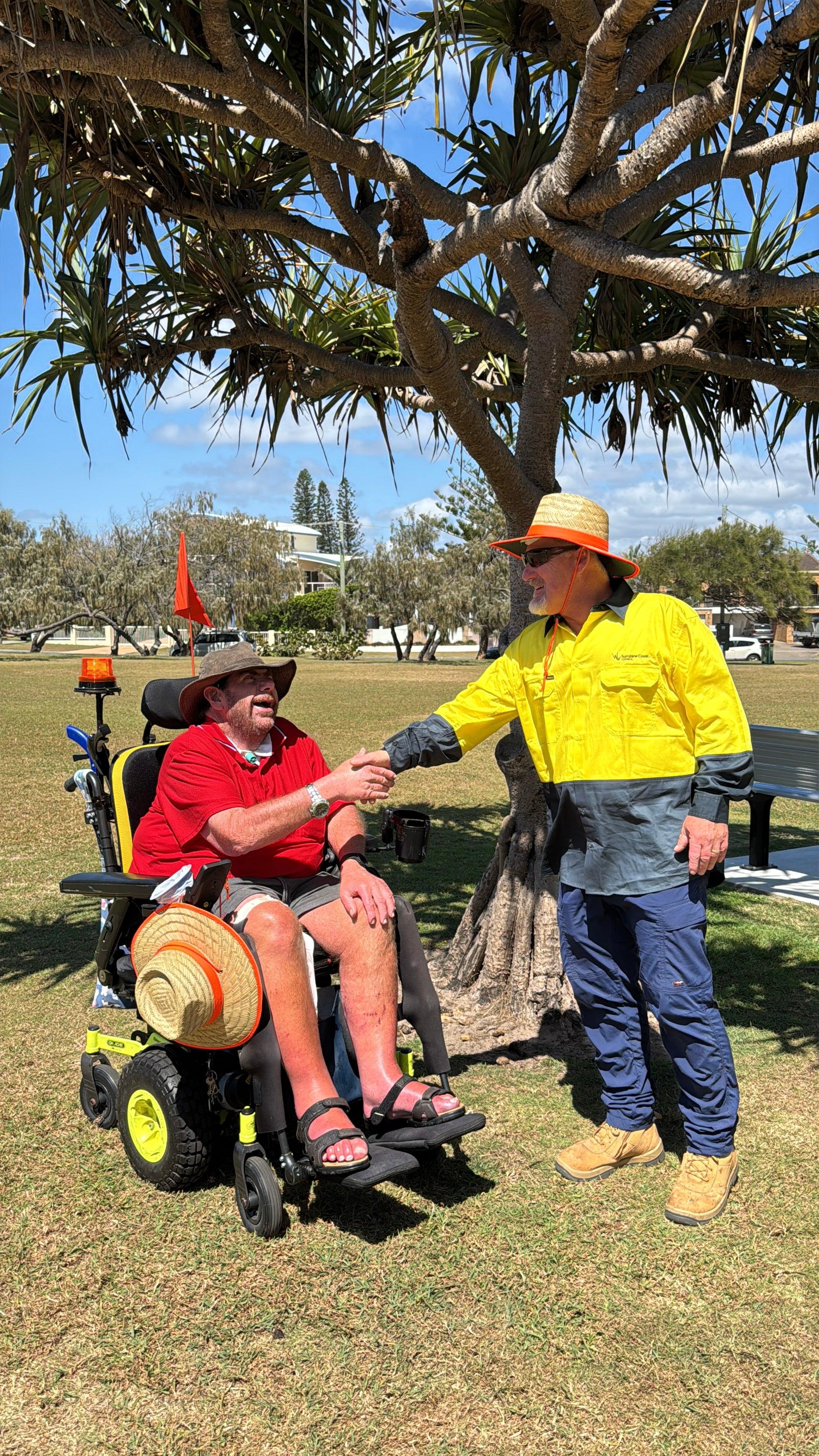 Local Peter Tutin shaking hands with Parks and Gardens worker Patrick Holden.