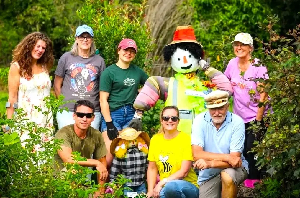 Little Mountain Community Garden group volunteers pose with their scarecrow.