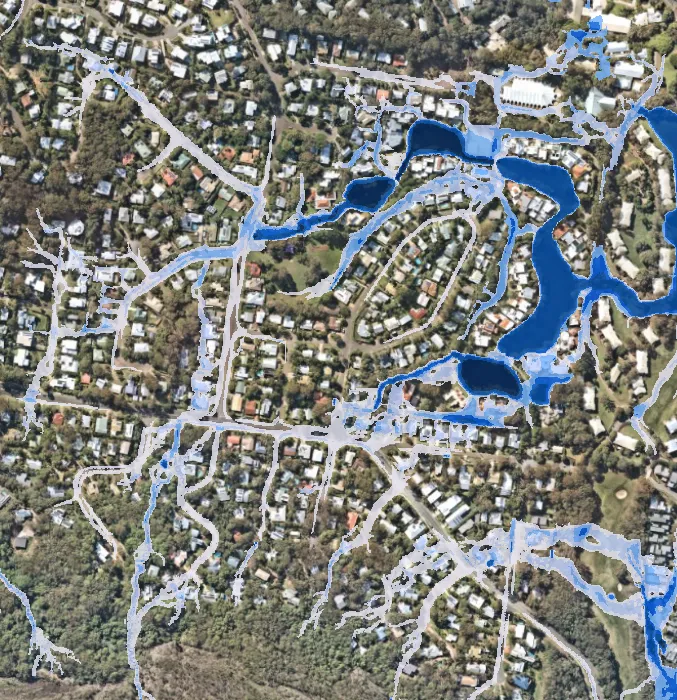 Bird's eye view of a residential region with waterways highlighted in blue.