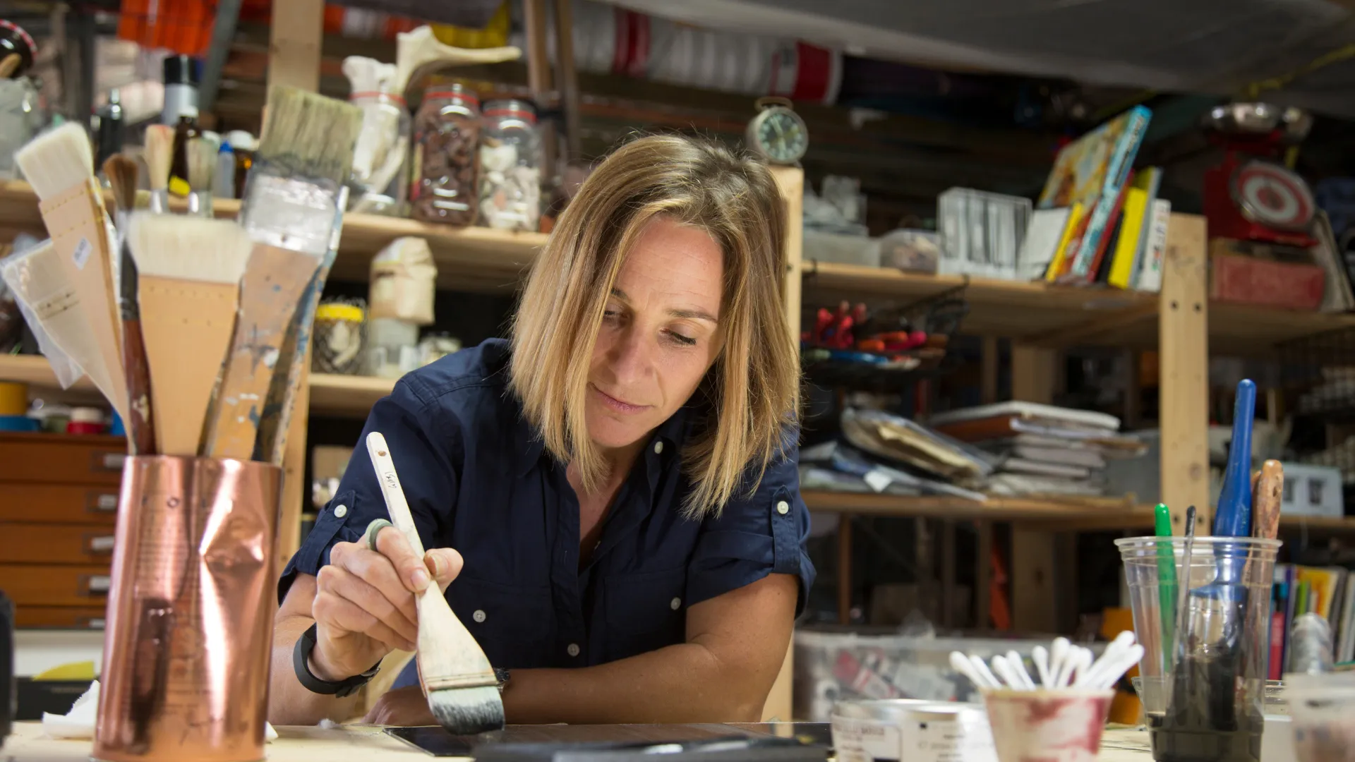 Artist painting in her studio