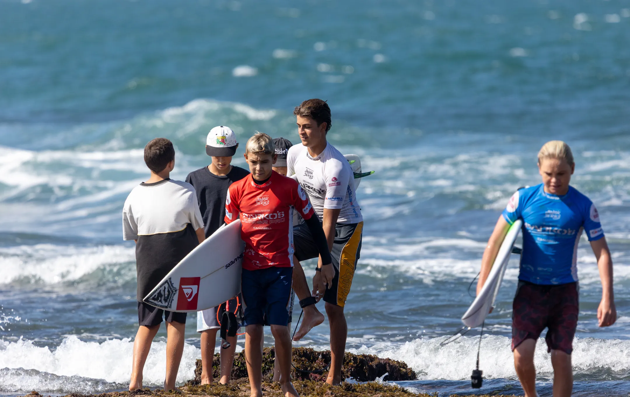 A group of children coming in from the surf