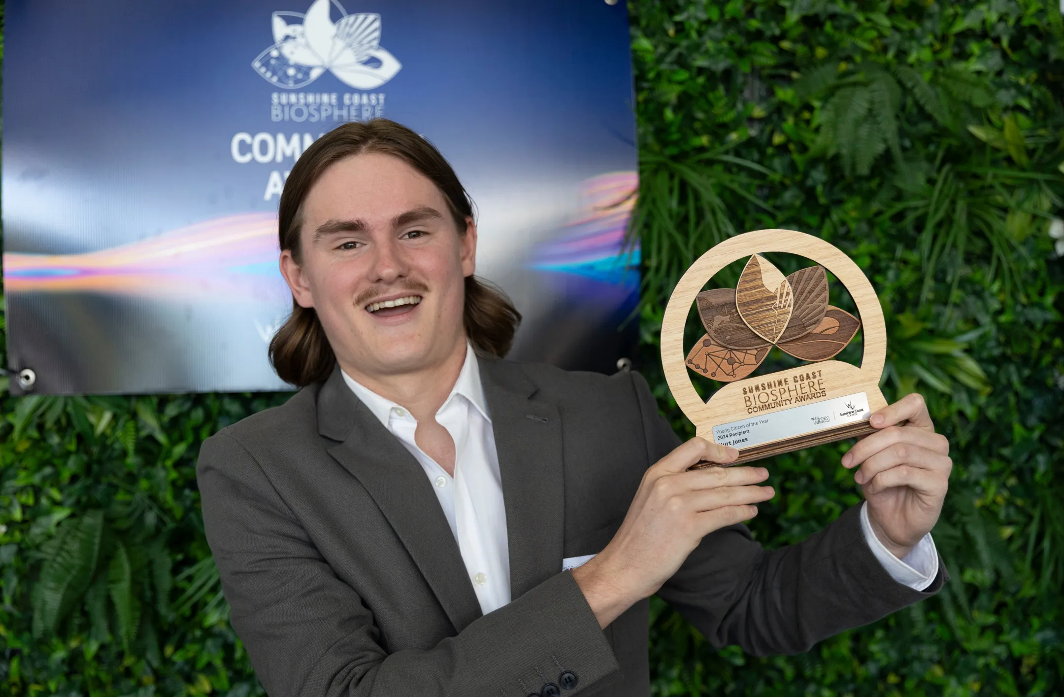 Kurt Jones stands with the award trophy