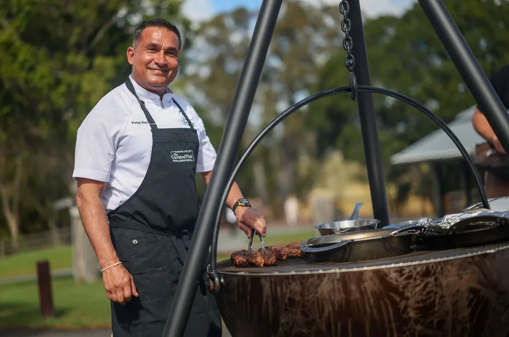 Chef Peter Kuruvita cooking meat on a bbq