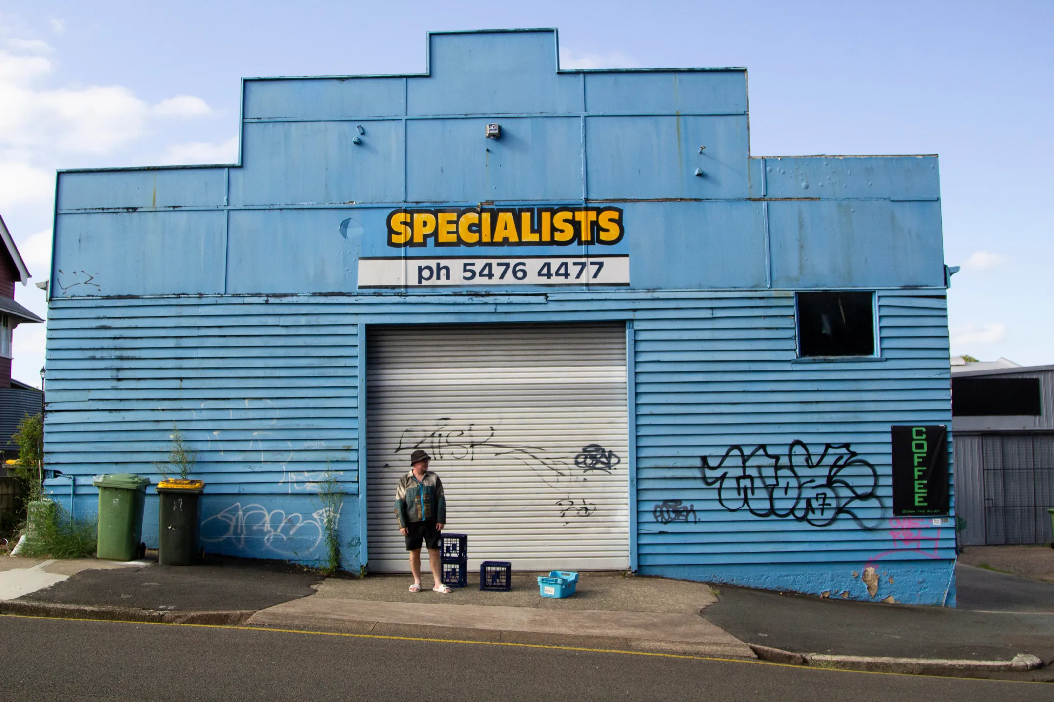 Man standing in front of the blue specialists building in Nambour