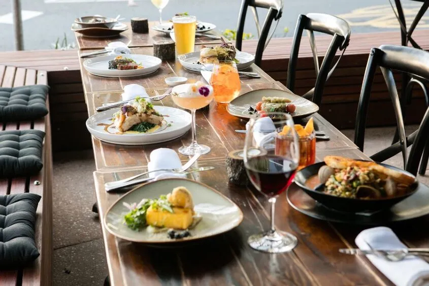 A table set with plates of food and drinks