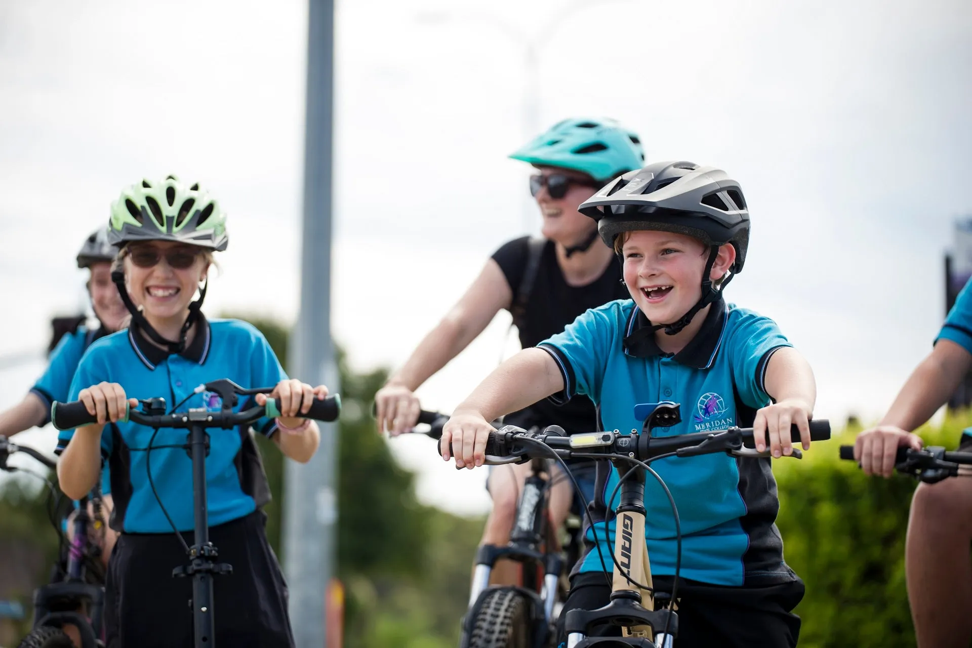 school children riding bikes and scooters to school