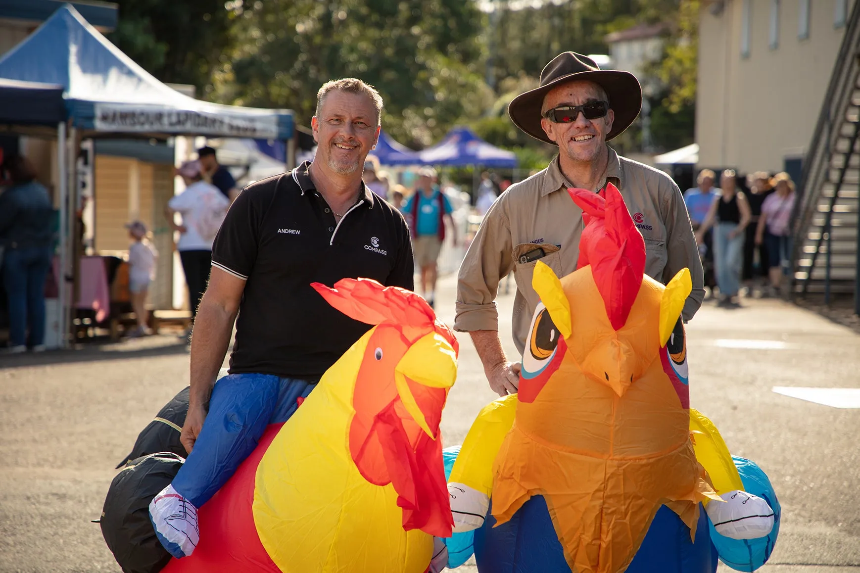 Two people wearing chicken / rooster costumes