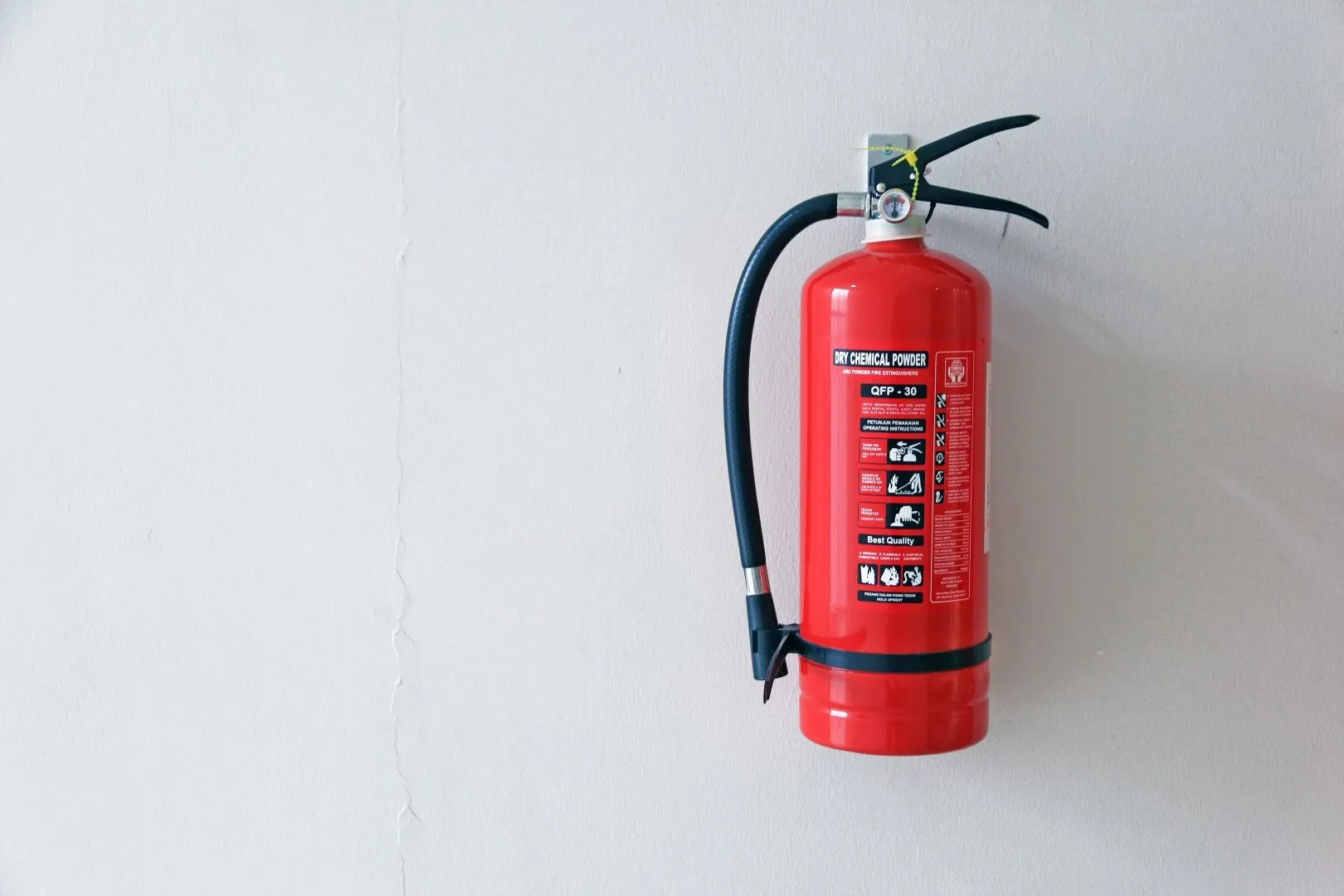 Single fire extinguisher screwed to a wall