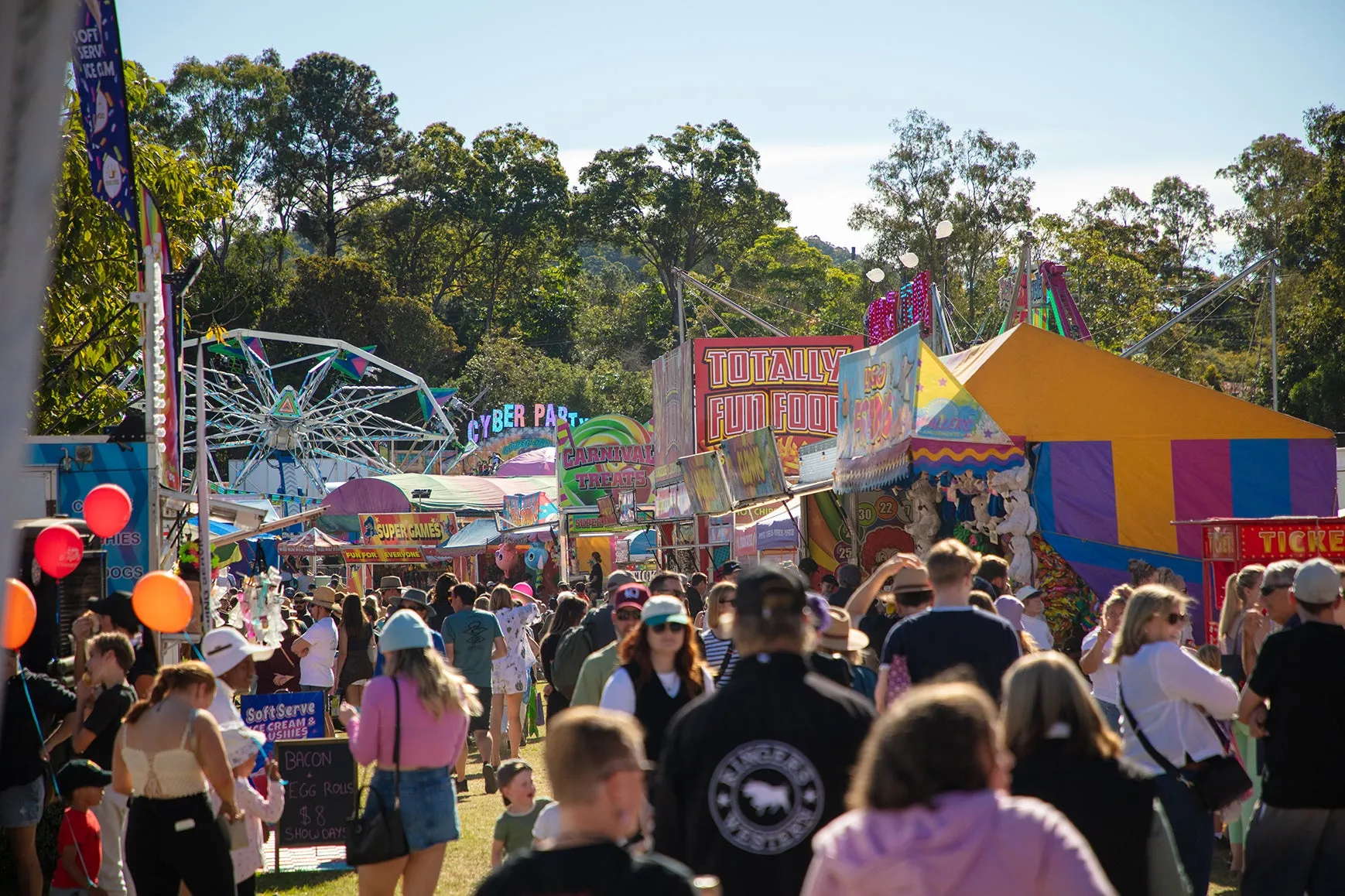 A crowd of people on their way to side show alley