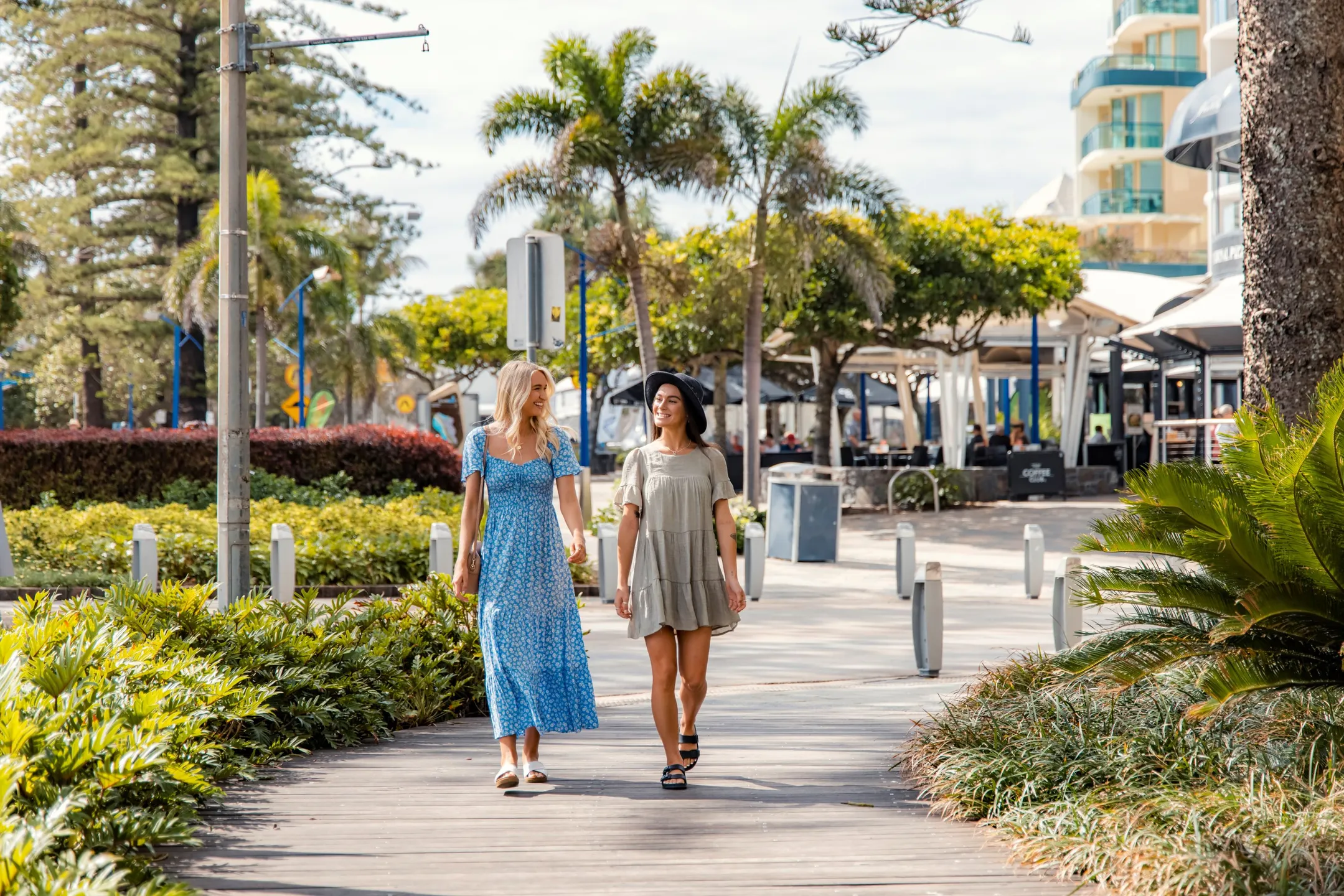 Two women walking along Mooloolaba Esplanade shopping.