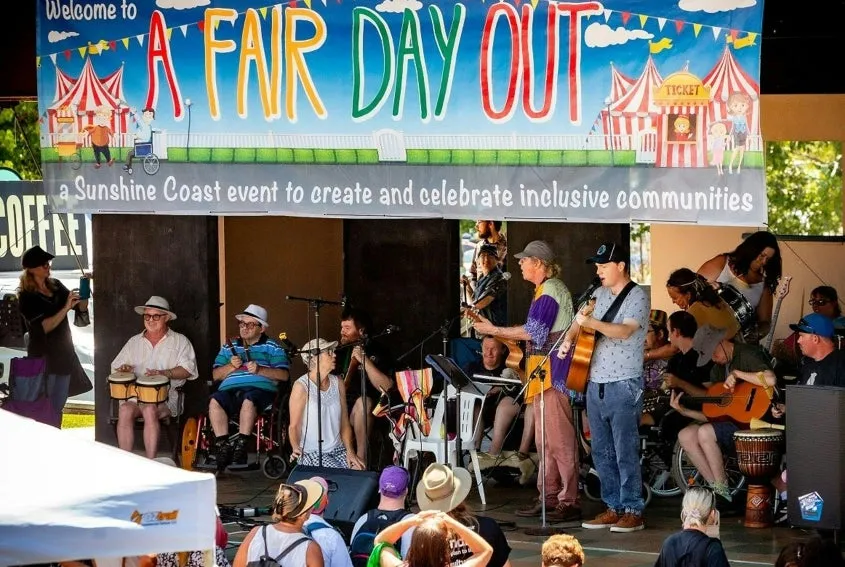 People watching a band on stage, with a big banner at the top - A Fair Day Out