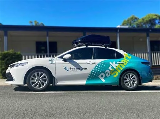 Sunshine Coast Council smart car parked in a parking bay in front of Caloundra depot office.