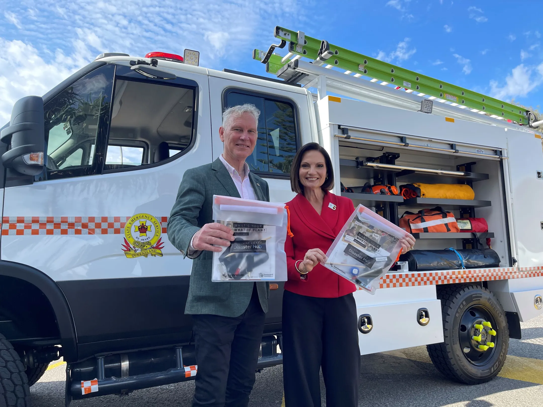 Mayor’s Natoli and Wilkie stand in front of an emergency response vehicle holding Council’s Get Ready packs.