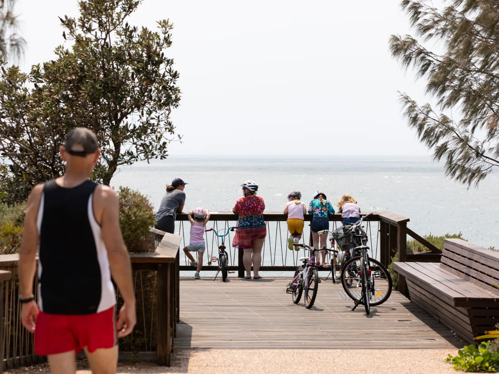 Walkers and bike riders enjoy the view of the ocean at the Coolum boardwalk.