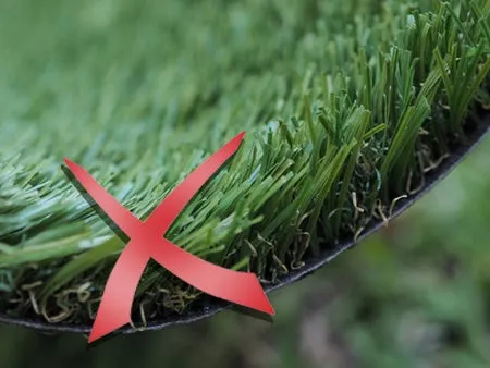 Artificial green turf with a big red cross over the grass.