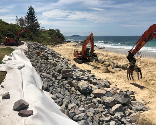 Placed rock seawall with 1:1.5 slope under construction at Mooloolaba 2020 (geofabric layer, filter rock and armour rock from left to right)