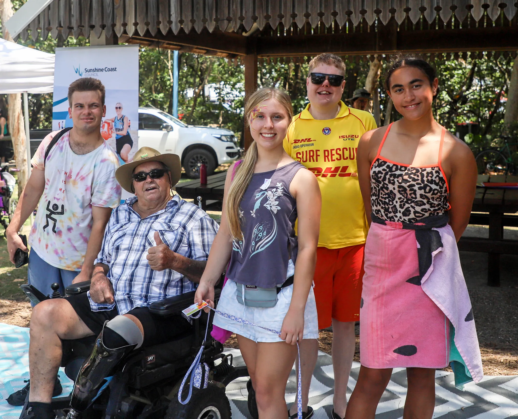 A group of people smiling in the park