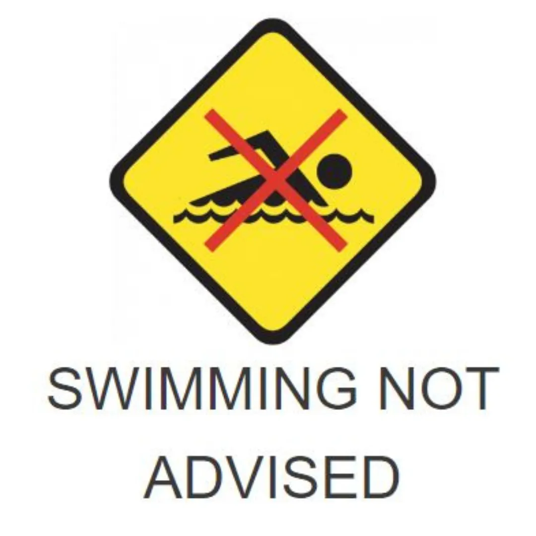 Yellow and black sign showing a person swimming with a large red cross over the picture. Swimming not advised written on the sign.