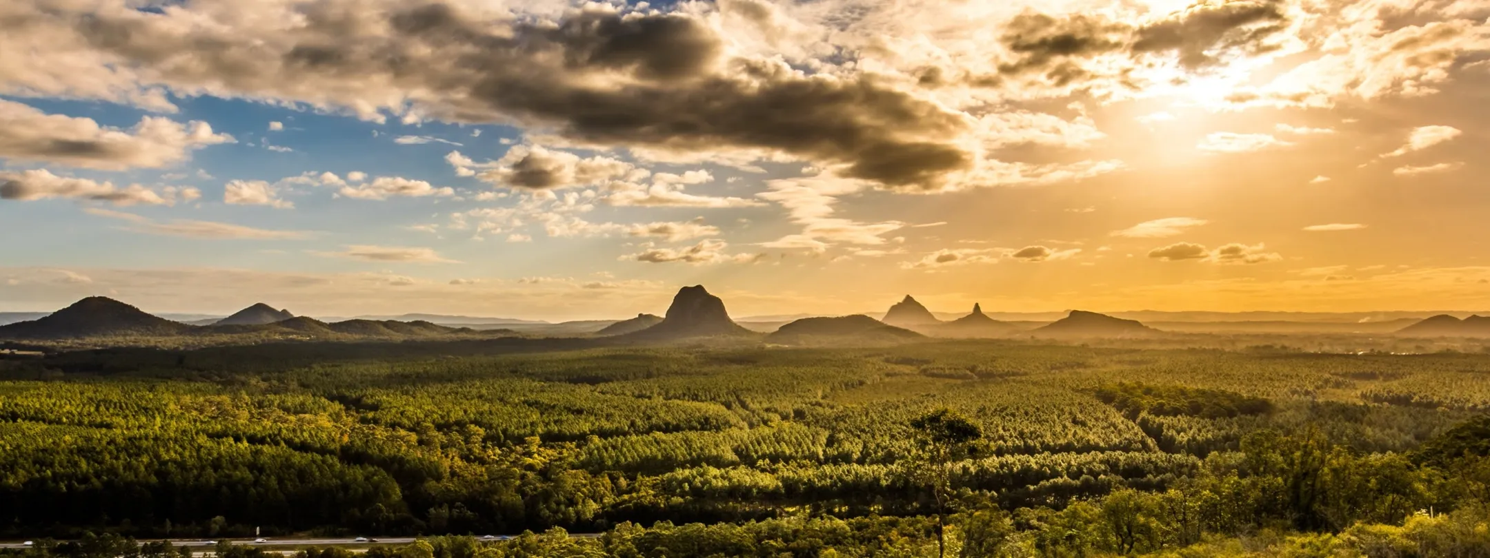 Panoramic view of the Glass House mountain range at sunset