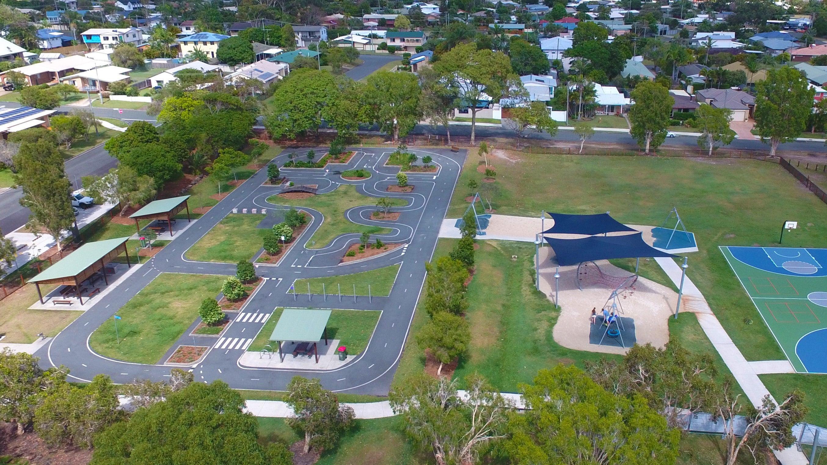 Areial view of playground and parkw ith shelters, bike track, swings and shade structures