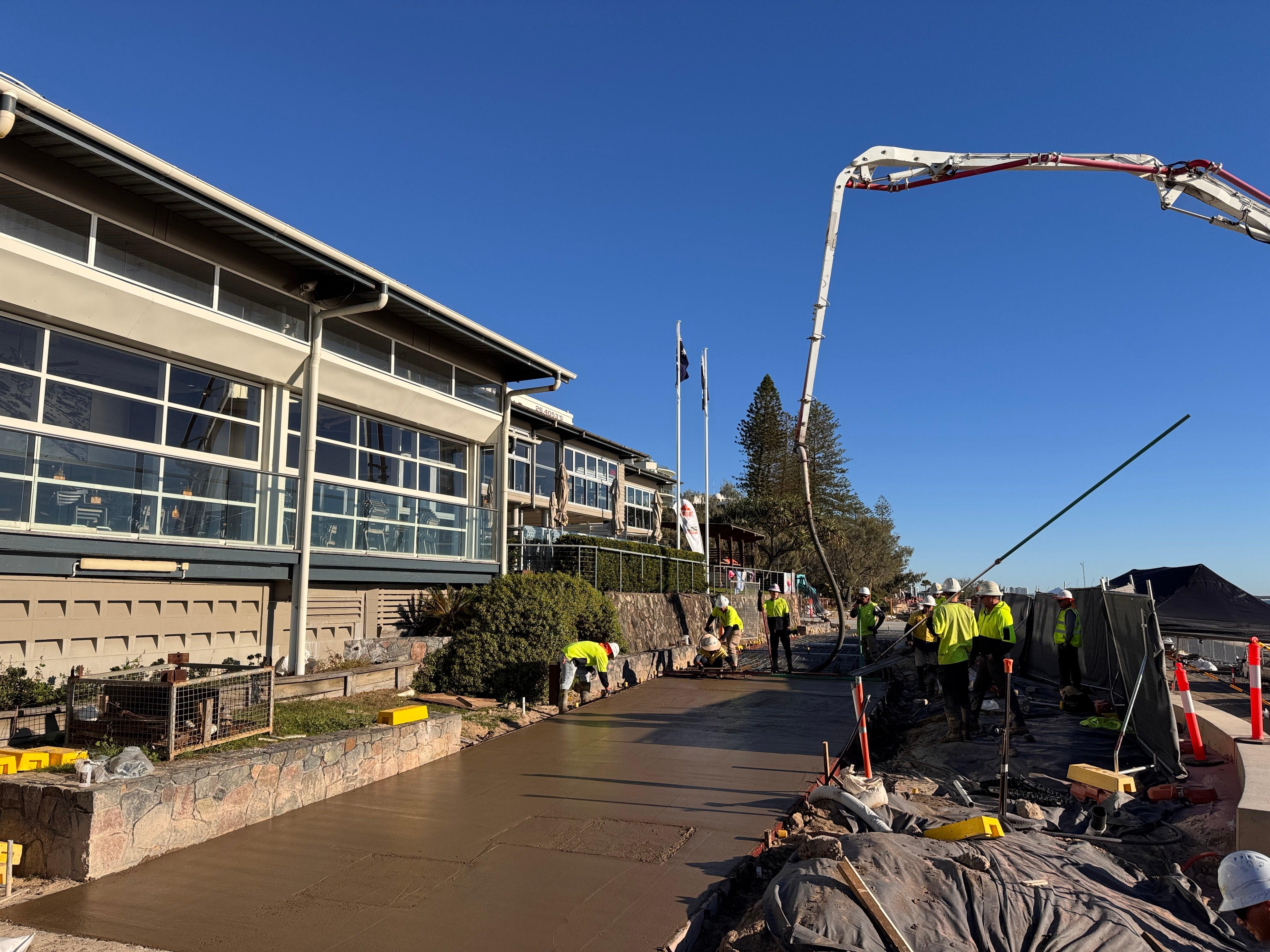 Construction crews pouring the new concrete pathway.