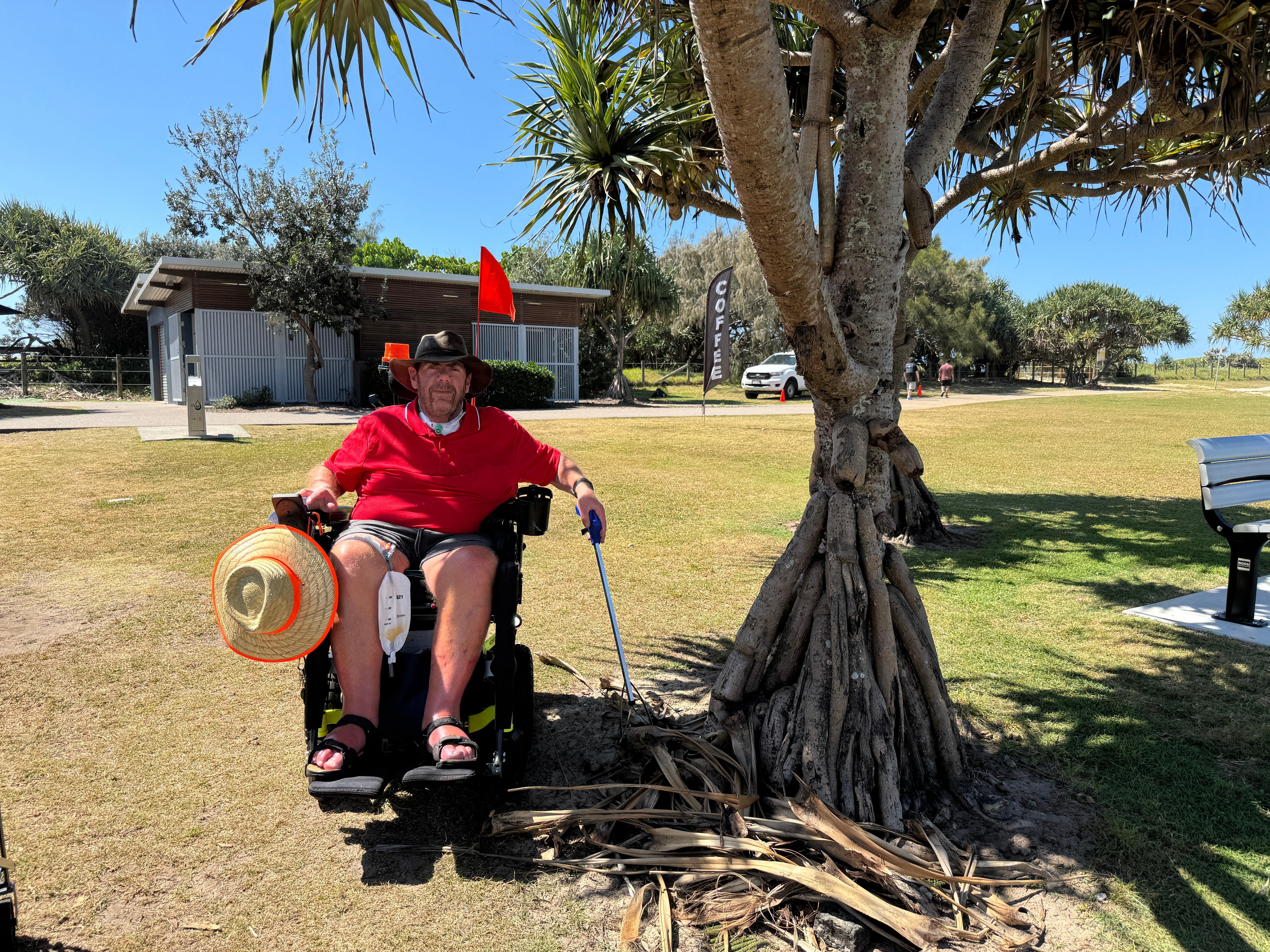 Local Peter Tutin picking up pandanus palm fronds from the ground.