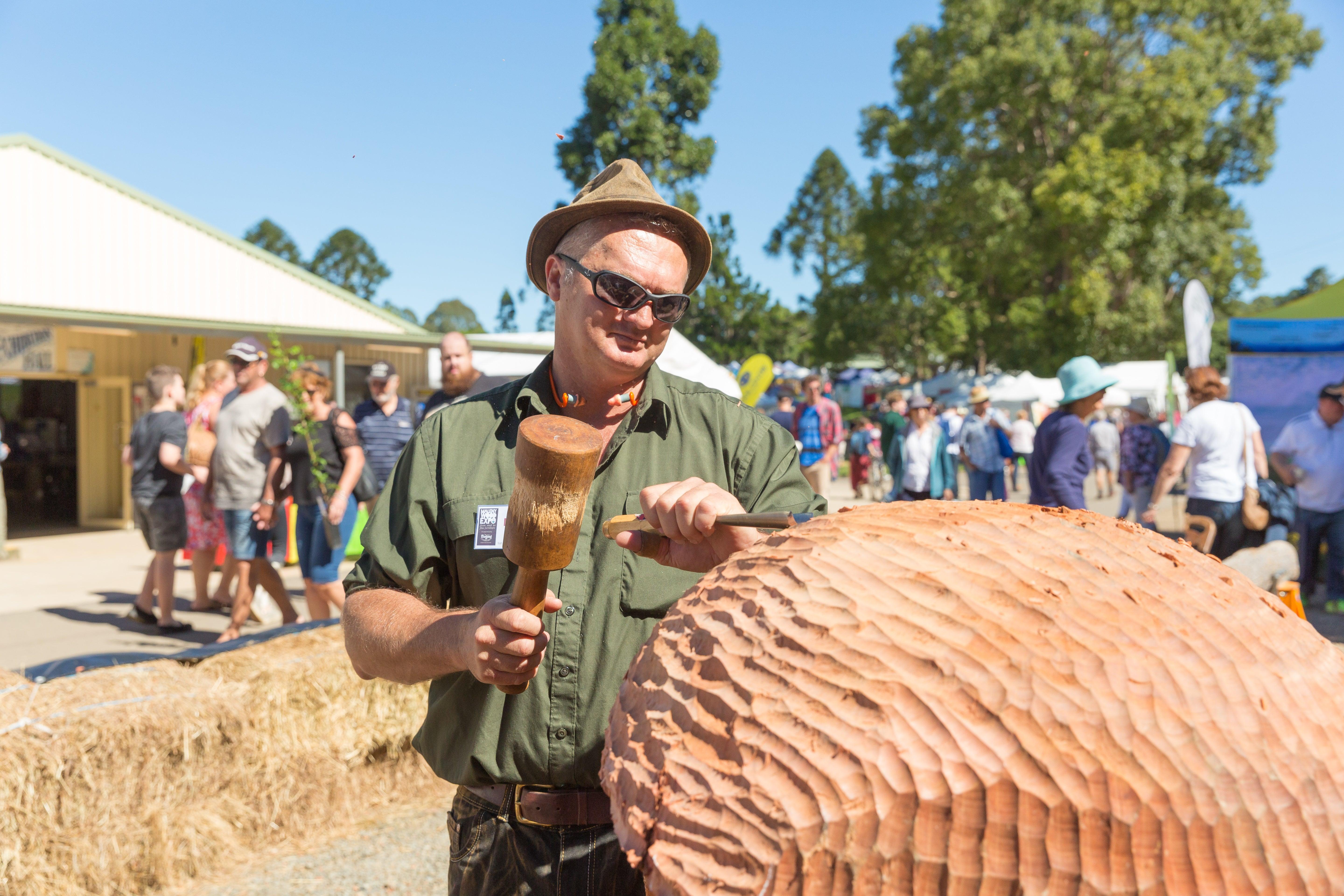 Maleny Wood Expo - man working on a wood piece