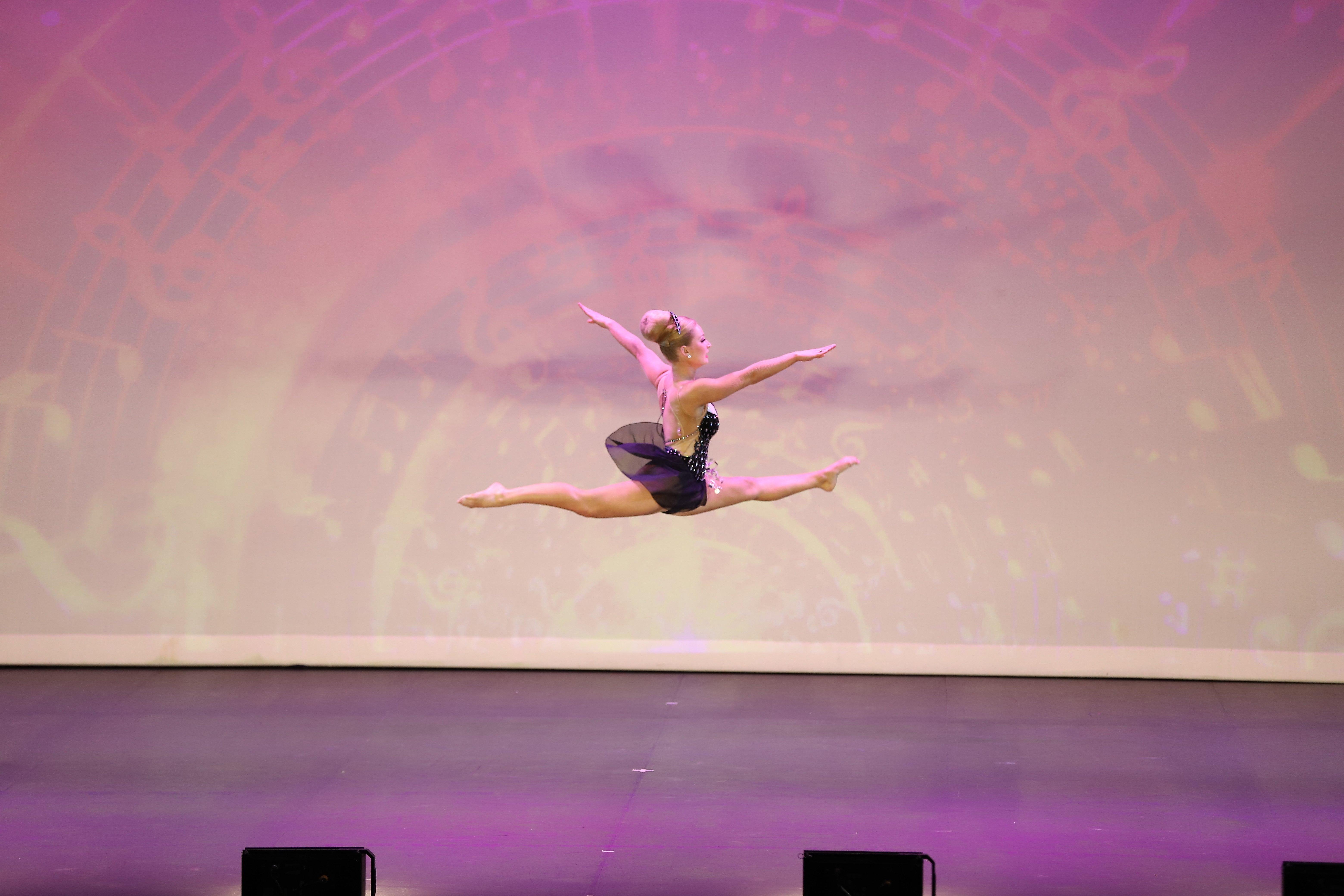 A gymnastic in flight during her routine.